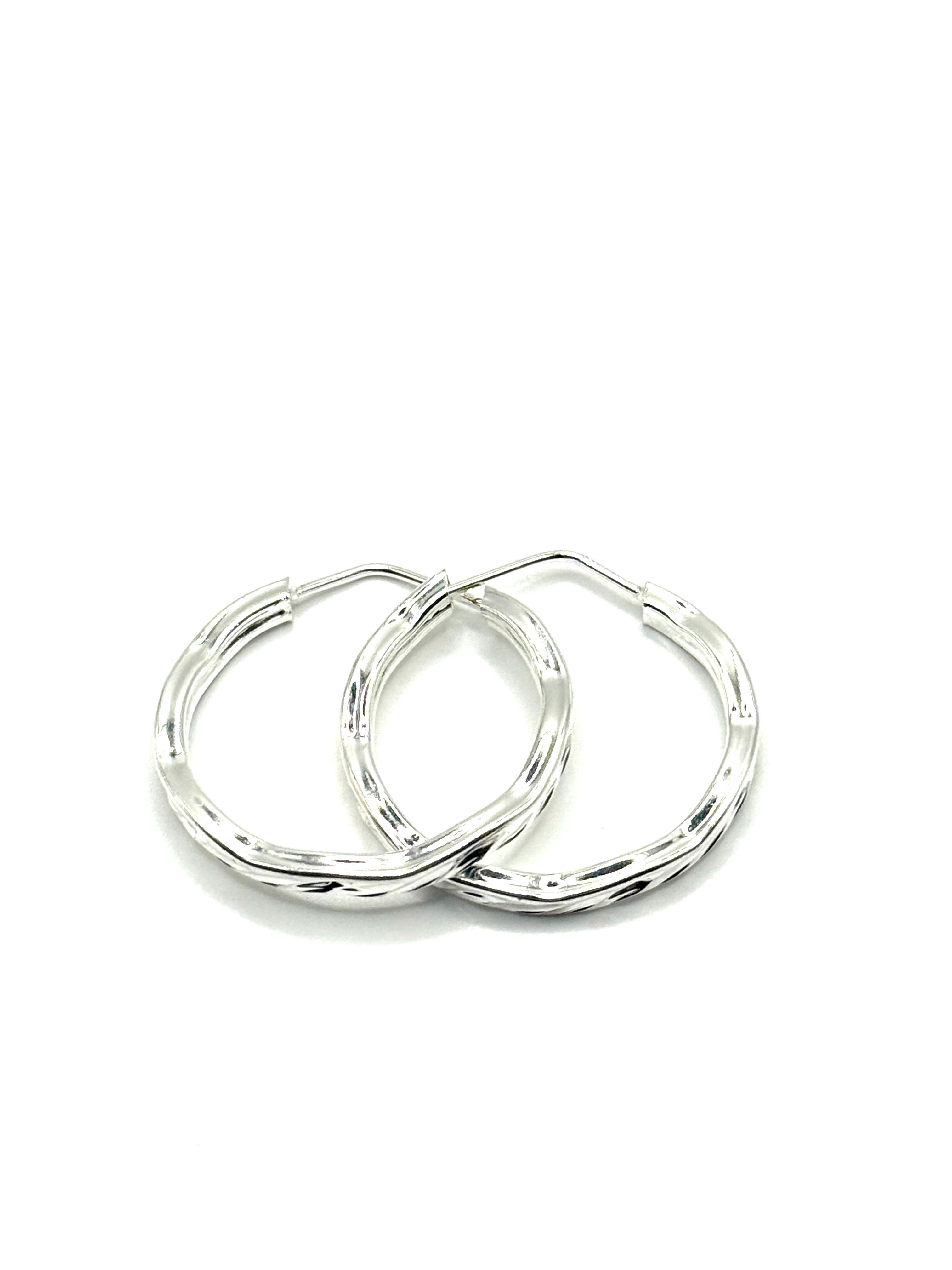 Woman’s slim hoop earrings